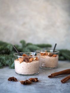 two small glass bowls filled with oatmeal and cinnamon on top of a table