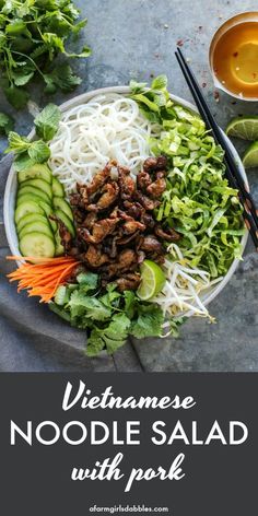 vietnamese noodle salad with pickles and cucumbers in a white bowl on a gray surface