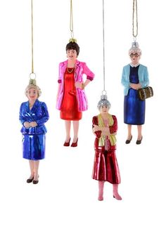 three christmas ornaments hanging from strings in the shape of women