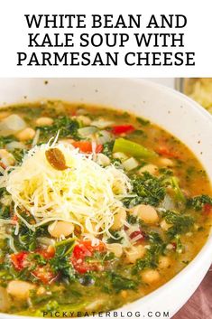 a bowl of white bean and kale soup with parmesan cheese on top