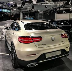 the rear end of a white mercedes car on display