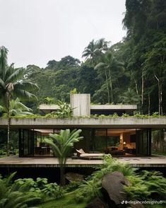 the house is surrounded by lush vegetation and trees