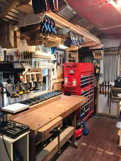 a workbench with tools hanging from the ceiling