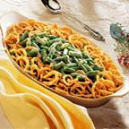 a casserole dish with green beans and noodles in it on a white table cloth