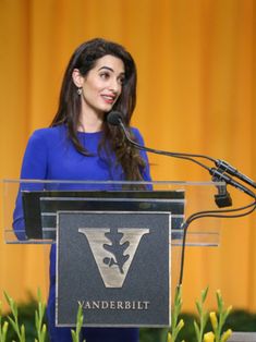 a woman standing at a podium in front of a microphone with the words vanderbilt on it