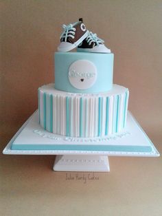 a blue and white cake with shoes on top