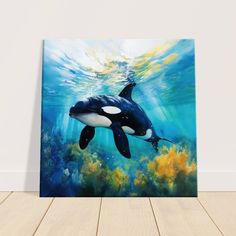 an orca whale swims under the water in front of a painting on a wall