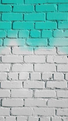 a white brick wall with blue paint on it