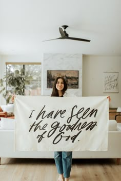 a woman holding up a sign that says i have seen the garden at 909