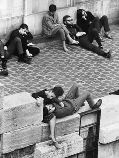 black and white photograph of people sitting on steps