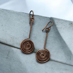 Spiral Copper Earrings Very common among Celtic and the Viking era, mostly used to symbolize growth, creation and fertility.  These are handmade by me and given a beautiful patina to bring out the character and beauty of the copper. They drop about 2.5" from top of ear wire I have added a clear coating to prevent further oxidation. Care Instructions: - Remove your jewelry before showering, sleeping, swimming or sweating. - Most pieces, unless otherwise specified, can be cleaned with a mild dish soap and soft toothbrush  if really necessary. Do NOT soak your jewelry or use any chemicals. - Clean your jewelry before and after each use with a soft dry polishing cloth.  >Please keep in mind when ordering that color settings on your screen and lighting in product photography vary so the product Bronze Spiral Earrings For Gifts, Bohemian Spiral Copper Earrings, Bohemian Copper Spiral Earrings, Nickel-free Bronze Spiral Earrings, Artistic Handmade Spiral Earrings, Hand Forged Copper Spiral Earrings, Viking Lagertha, Lagertha Shield, Shield Maiden