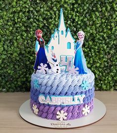 there is a birthday cake with frosting and decorations on the top that looks like disney's castle