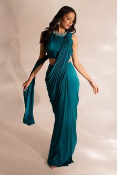 Teal pre-draped saree in a plain base. Comes with a matching embellished neck blouse. Components: 2 Pattern: Solid Neckline: Round Sleeve Type: Sleeveless Fabric: Skirt: Lycra, Blouse: Tussar Silk Color: Blue Other Details:  Attached lining Weight: 1 kgs Note: Belt worn by the model is not for sale Occasion: Sangeet,Cocktail - Aza Fashions Pre Draped Saree, Saree Wearing Styles, Draped Saree, Blue Color Combinations, Saree Wearing, Simple Saree Designs, Fabric Skirt, Color Combinations For Clothes, Simple Sarees