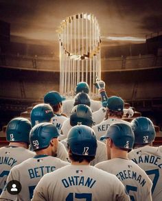 a group of baseball players standing in front of a trophy