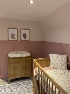 a baby's room with two cribs and a dresser in the corner