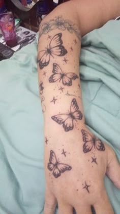 a person's arm with butterflies on it