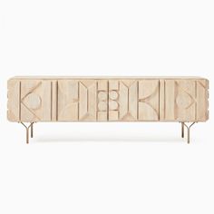 the sideboard is made out of wood and has geometric designs on it, as well as metal legs