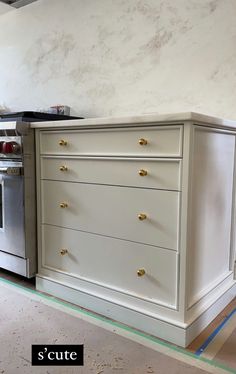 a kitchen with white cabinets and an oven