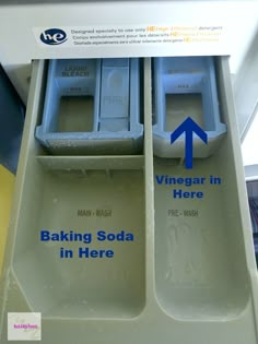 two trays with baking soda in them sitting on a train seat, labeled vinegar in here and baking soda in here