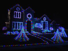 a house covered in christmas lights at night