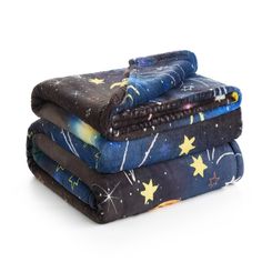 three blankets stacked on top of each other with stars and moon designs all over them