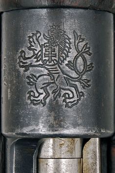 a close up of a metal object with a lion on it's back end