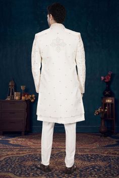 This luxurious mens sherwani, style code U2-S329, features an open jacket design adorned with intricate thread embroidery. Perfect for sophisticated, high-end occasions, it exudes exclusivity and elegance. Make a statement and elevate your ensemble with this elevated piece. Long Embroidered Elegant Nehru Jacket, Embroidered Long Elegant Nehru Jacket, Elegant Long Embroidered Nehru Jacket, Reception Bandhgala With Pearl Embroidery, Elegant Long Outerwear With Intricate Embroidery, Reception Sherwani With Pearl Embroidery In Traditional Drape, Traditional Wedding Sherwani With Pearl Embroidery, Elegant Outerwear With Chikankari Embroidery For Eid, Festive Sherwani With Pearl Embroidery