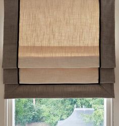 an open window with roman shades on it