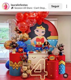 the wonder woman birthday party is set up with balloons, decorations and other things to celebrate