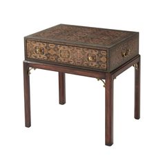 a wooden table with two drawers on one side and an ornate design on the other