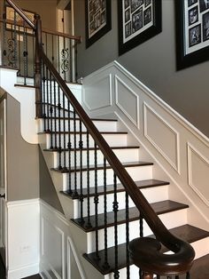 there is a stair case on the wall next to the bannister in this house