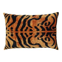 an orange and black tiger print pillow on a white background