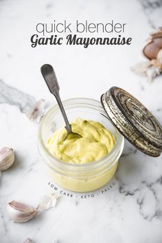 garlic mayonnaise in a glass jar with a spoon