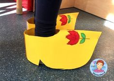 a person standing inside of a yellow shoe box