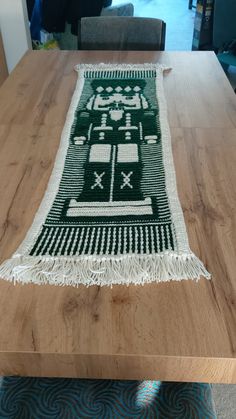 a table with a green and white rug on it