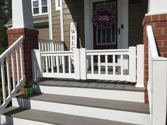 a white porch with steps leading up to the front door and welcome sign on it