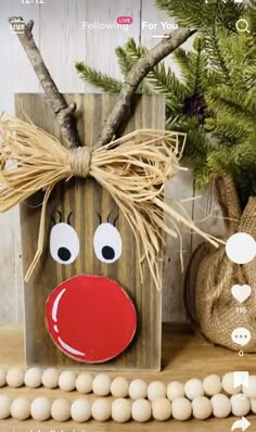 a wooden block with a reindeer face on it next to some burlwood balls