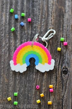 a keychain with a rainbow on it sitting on top of a wooden table