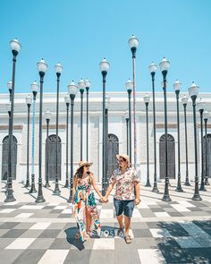 two women walking down the street holding hands