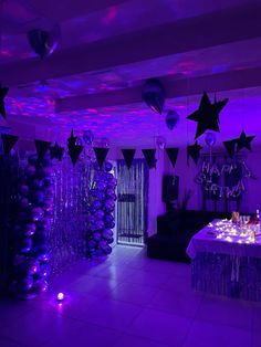 a party room with purple lighting and balloons