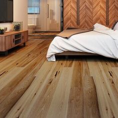 a bedroom with wood flooring and white bedding