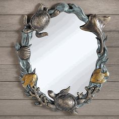 a mirror that is on the side of a wall with fish and turtle around it