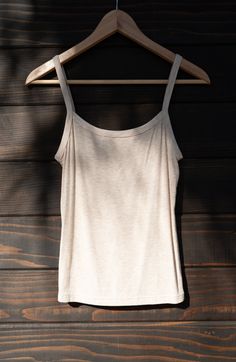 A 90's inspired elevated wardrobe essential. Made of locally sourced buttery soft upcycled rib, the Soleil is a tank top with a snugly fitting gently curved neckline, bra-friendly straps, and falls to high hip length. We consider this one true to size, and if in-between could be sized either up or down based on your preference. Made to layer - choose a pair and receive $10 off both (automatically applied at checkout). Seamless Tank Top With Straps, Stretch Seamless Camisole For Everyday, Everyday Seamless Camisole Tank Top, Stretch Tank Top For Loungewear, Everyday Seamless Cami Tank Top, Second-skin Sleeveless Tops For Everyday, Everyday Sleeveless Second-skin Tops, Everyday Second-skin Sleeveless Tops, Tank Top With Delicate Straps For Loungewear