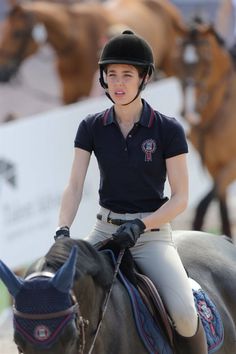 a woman riding on the back of a brown horse