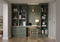 a desk with a laptop on top of it in front of some bookshelves