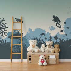 there are many stuffed animals on the shelf in front of this wallpapered room