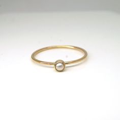 Elegant and dainty pearl ring in 14k gold filled! Perfect for your bridesmaids, graduation gift for your loved ones, or simply for yourself! They are great by themselves and are also stackable with other rings as pictured. Pearl is June birthstone What you will receive.. ONE 1mm 14K yellow gold filled ring with 3mm genuine white fresh water pearl For 14k solid gold option, please contact me!! All items are handmade with love and care in my little studio! If you have a sizing question or a specia Delicate Gold Stackable Pearl Ring, Everyday Gold Ring With Pearl Charm, Delicate Rose Gold Pearl Ring In 14k, Delicate Stackable Pearl Ring For Anniversary, Stackable 14k Gold Pearl Ring With Round Band, Dainty 14k Yellow Gold Moonstone Ring, Minimalist 14k Yellow Gold Pearl Ring, Classic 14k Gold Stackable Pearl Ring, Pearl Stackable Promise Rings