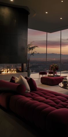 a living room filled with furniture and a fire place in front of a window overlooking the city