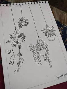 a drawing of flowers hanging from strings