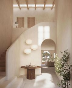 the interior of a house with white walls and flooring is lit by natural light